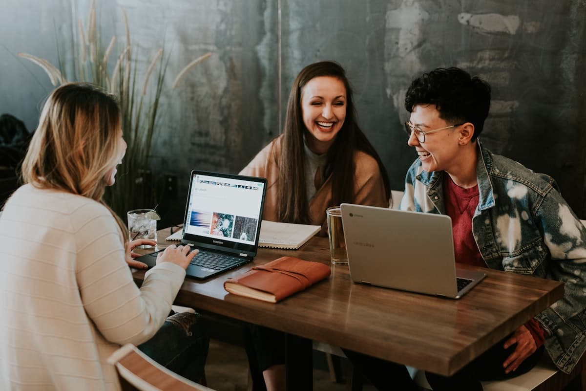 Business team collaborating around laptops during an AI workflow setup session